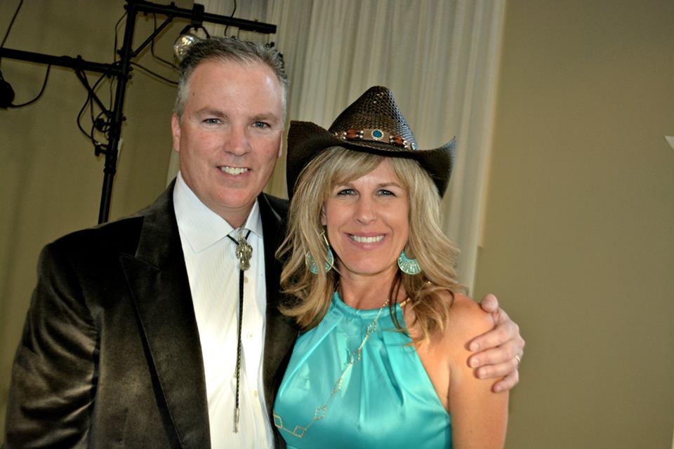 Bev wearing cowboy hat dressed up with her husband