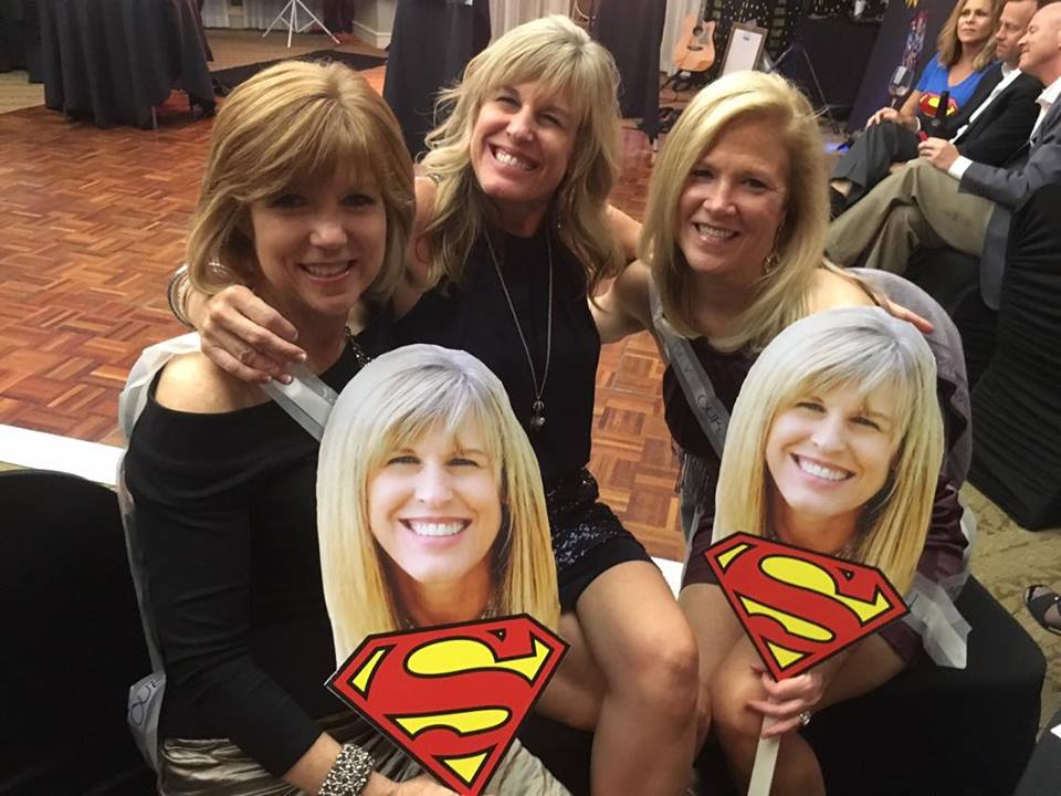 Bev and her friends with Superman signs