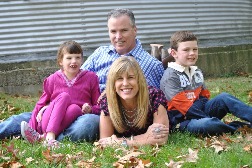 Bev and her family in the grass full image